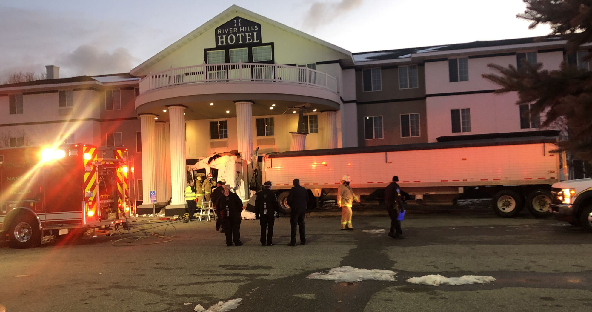 Semi crashes into hotel